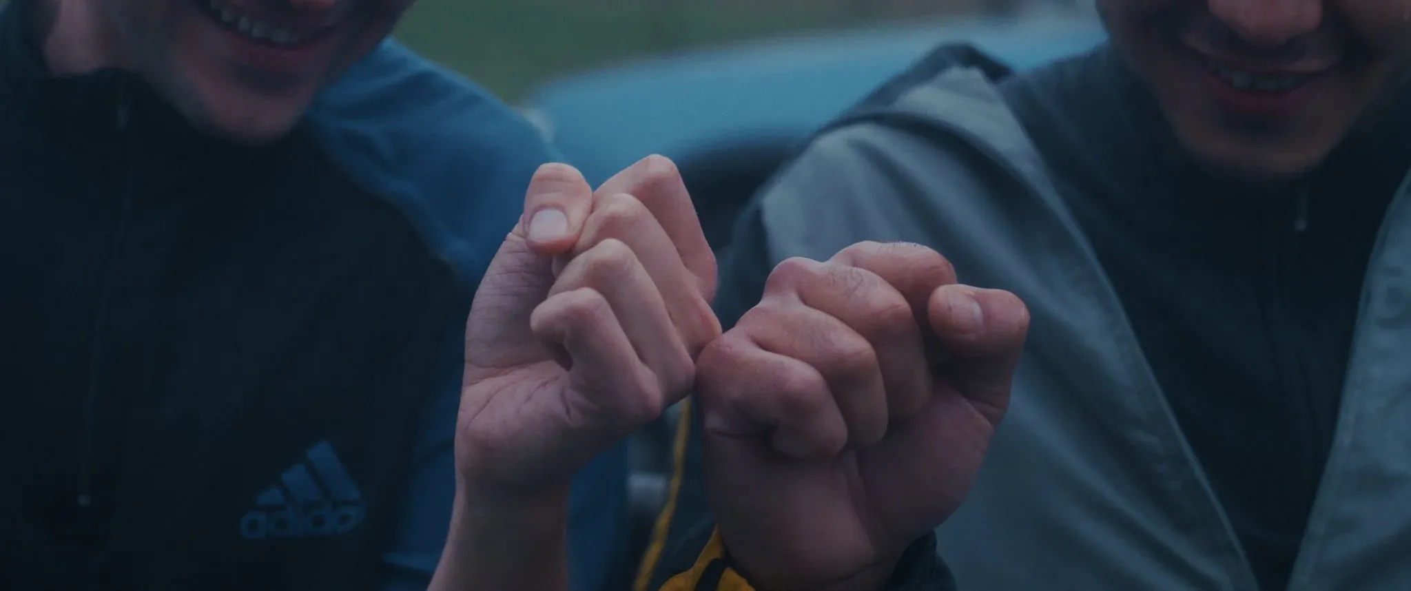 Close-up of two friends' hands in Still Hear You